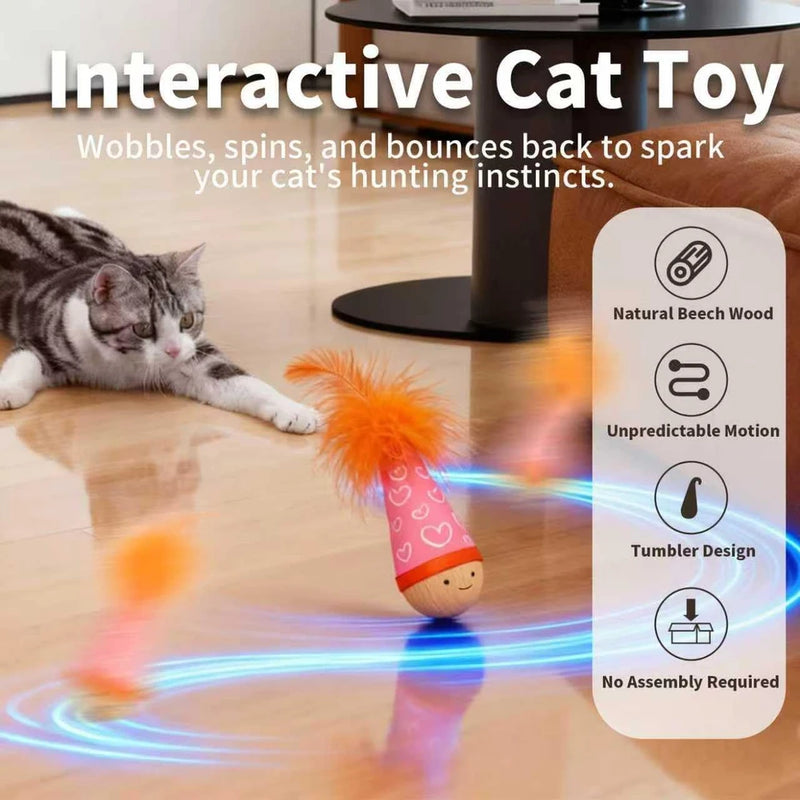 Interactive cat toy with a cat playing with it on a wooden floor.